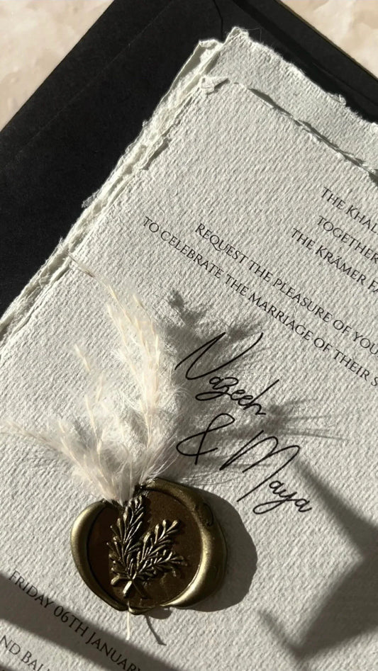 Hochzeitseinladung aus Büttenpapier mit Goldsiegel und Trockenblume, edles Design