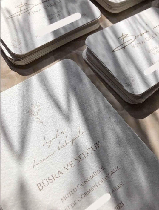 Elegante Hochzeitseinladungen aus Büttenpapier mit floralem Design und abgerundeten Ecken